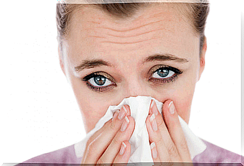 Woman with allergic rhinitis sneezing