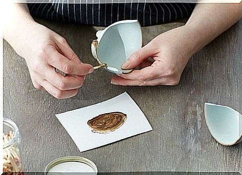 Person arranging a piece of pottery