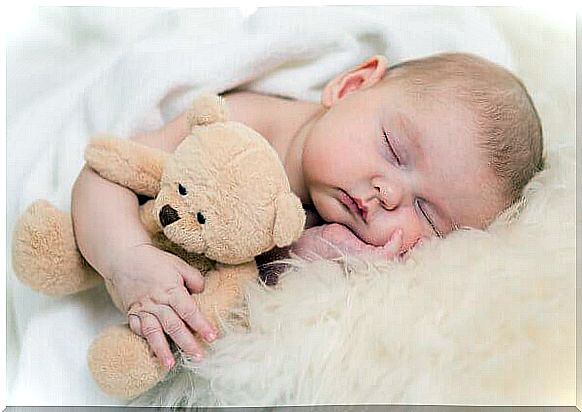 baby sleeping with teddy bear