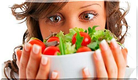 woman holding greek salad