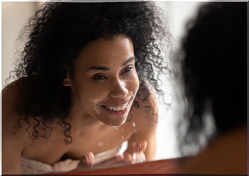 woman washing her face